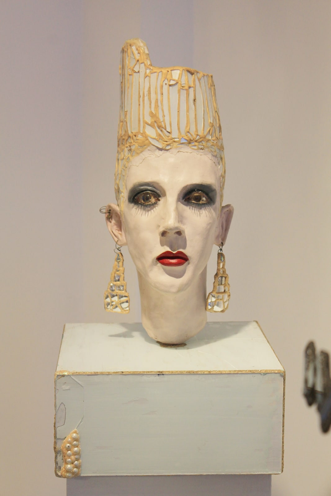 Mixed media portrait bust by British sculptor Andrew Logan. With decedent jewellery and a glamorous appearance.