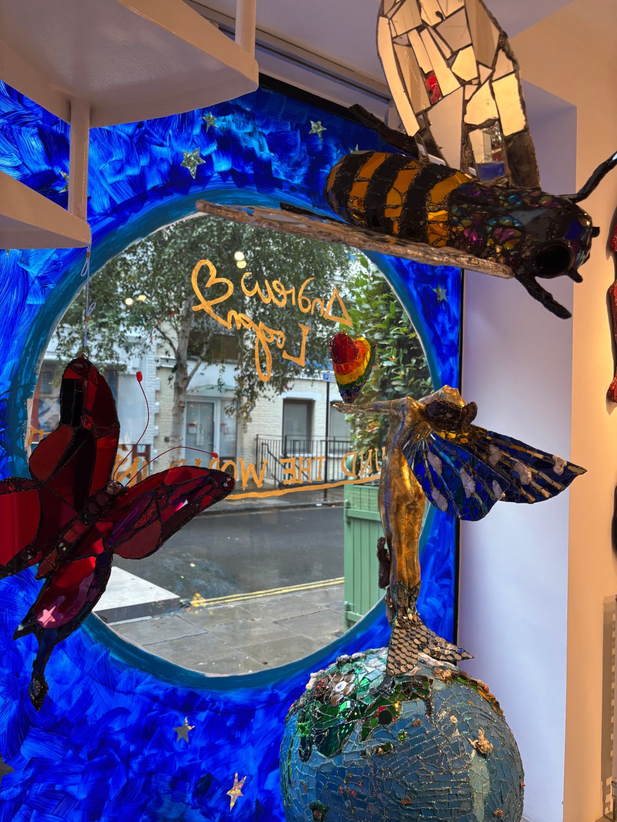 A colourful sculpture by Andrew Logan, celebrating life and the planet, in shimmering gold