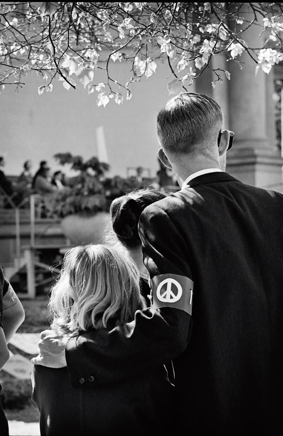 Black and white photograph by Jim Marshall of a man hugging a girl during a peace walk, available at the Rebecca Hossack Art Gallery.