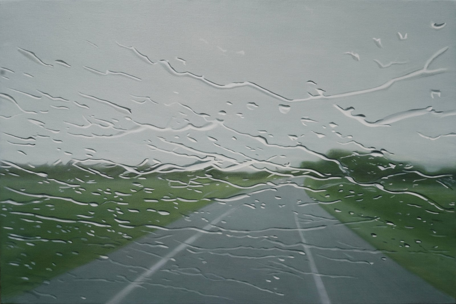 A road leading to a grey sky horizon with grassy banks on either side, seen through a glass screen with water droplets scattered across it. By artist Esther Nienhuis.