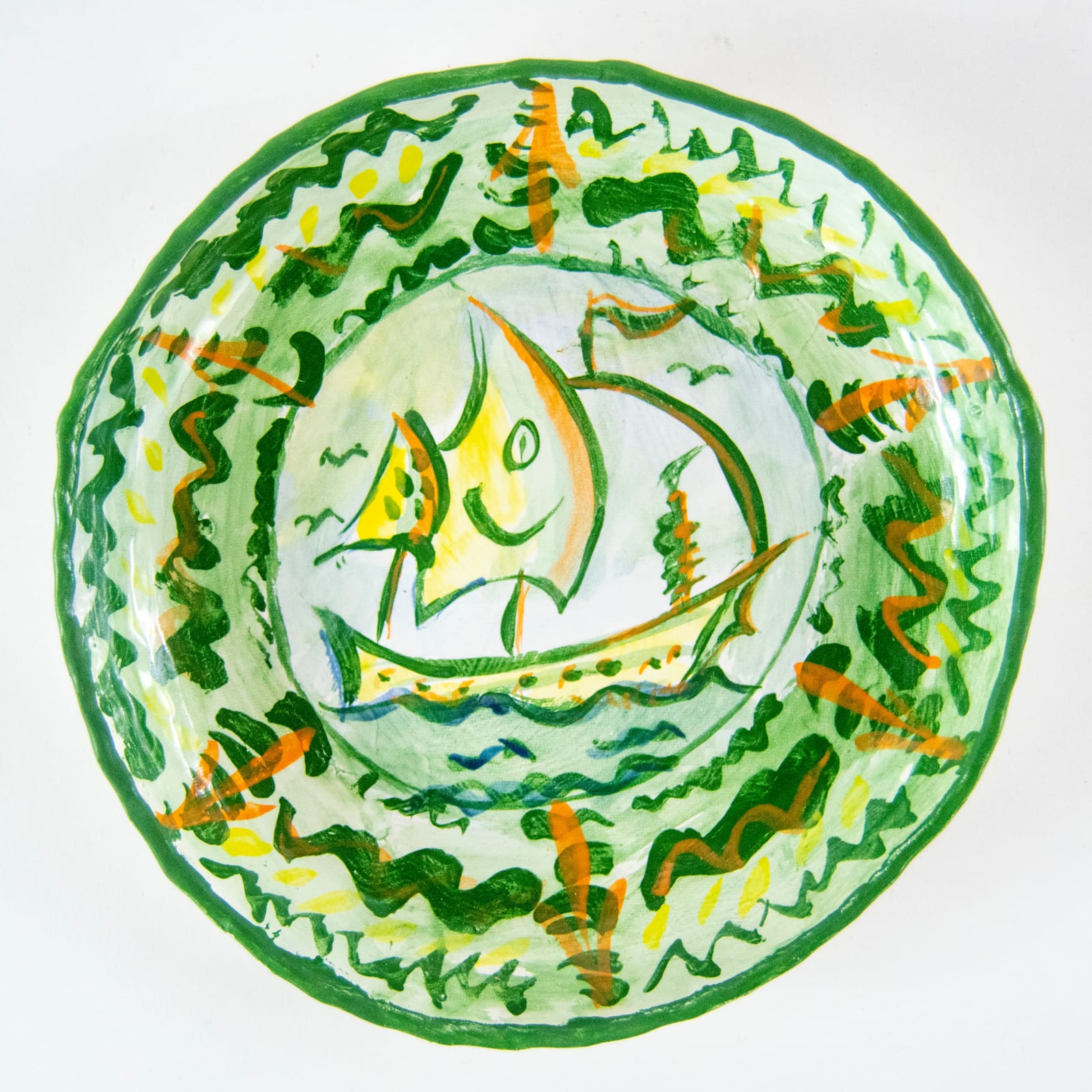A decorative plate with a sea ship at its centre by artist Reniel Del Rosario.