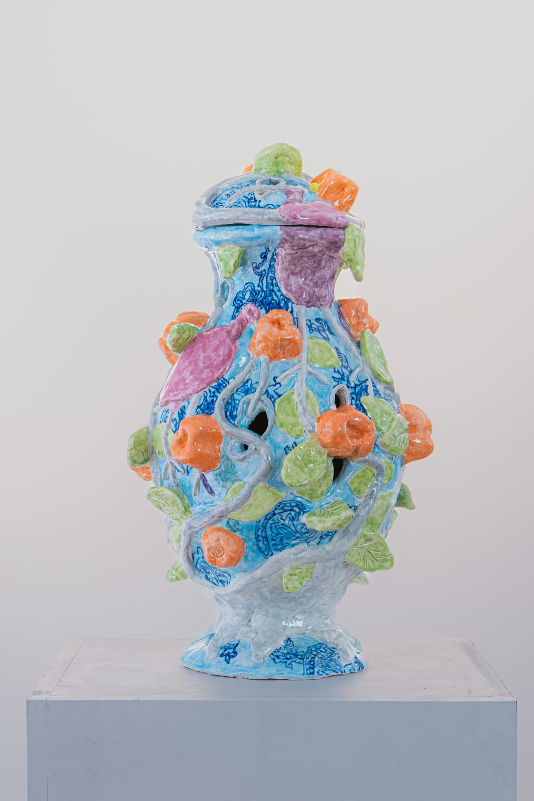 Fons van Laar, Blue ceramic vase with orange details and green leaves