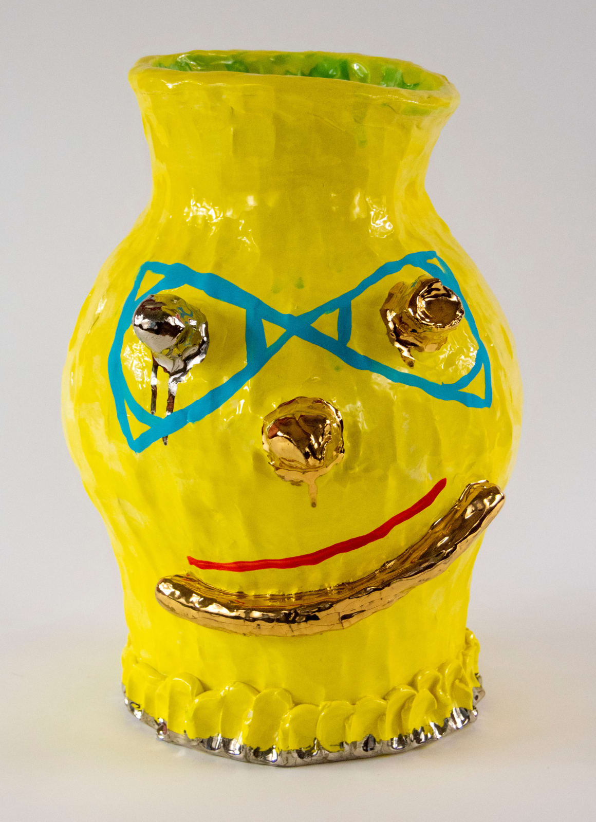 A vase with a face of gold details by artist Reniel Del Rosario.