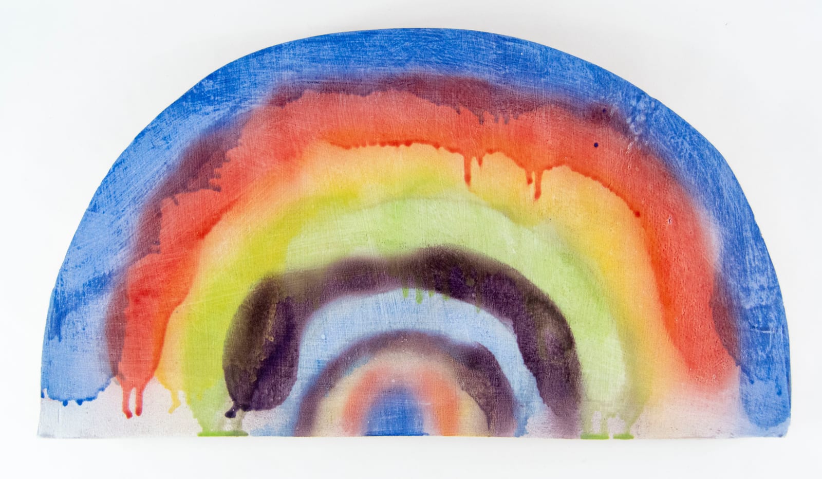 A piece of ceramic with a rough rainbow painted onto the side by artist Reniel Del Rosario.