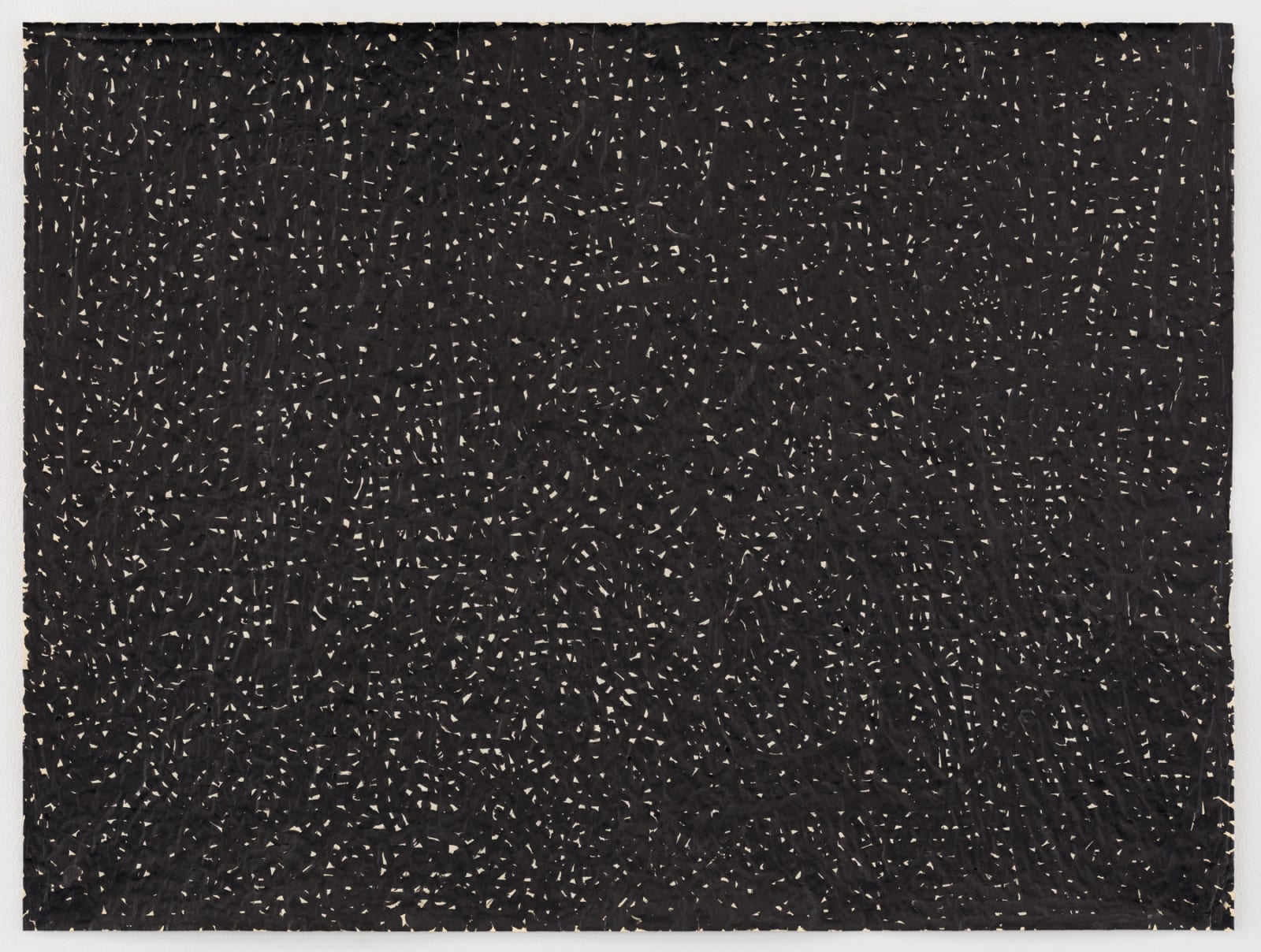 Numerous tiny white specs on a black background