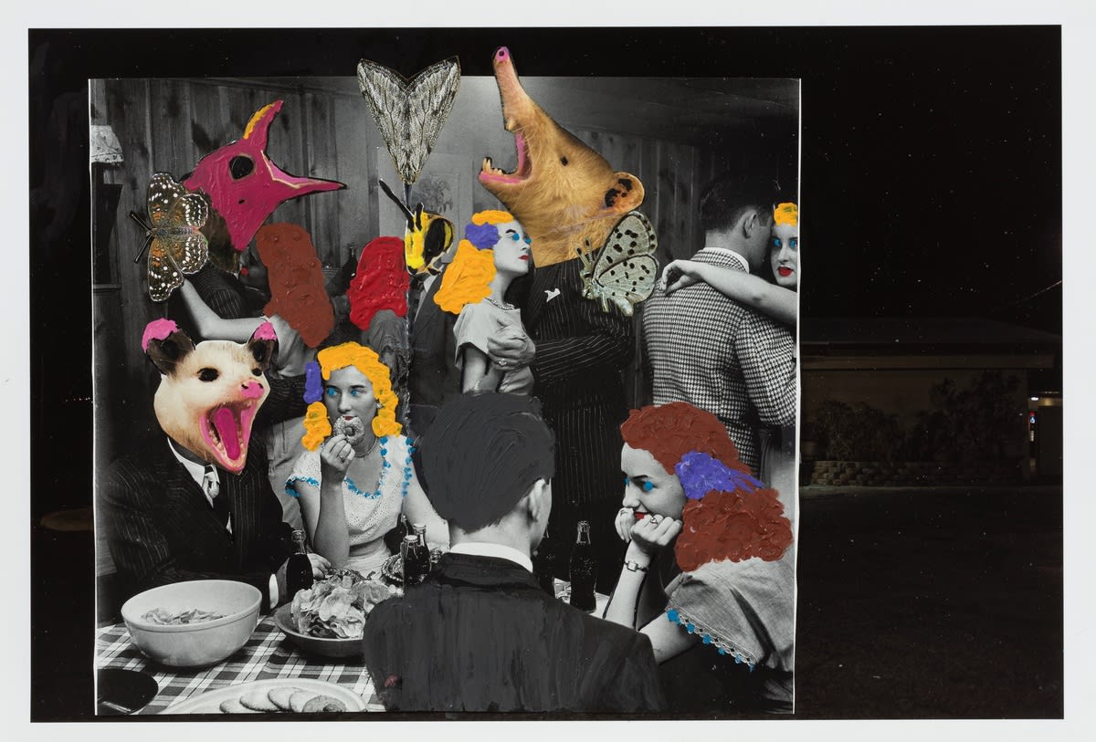 A dinner party consisting of people sitting at a table and others dancing behind them. Some of the men have animal heads, and some of the woman have colorful drawn on hair.