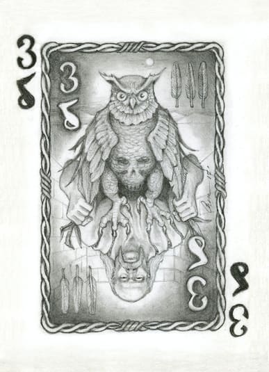 A black and white number 3 playing card with an own on the top and an upside down bearded man on the bottom
