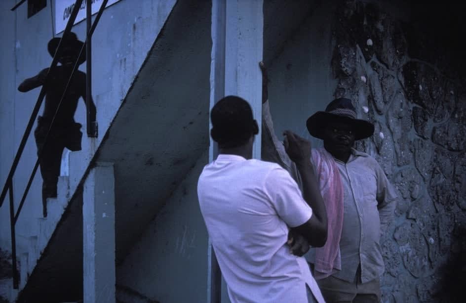 Alex Webb, Ft. Pierre (three black men with staircase), 1989