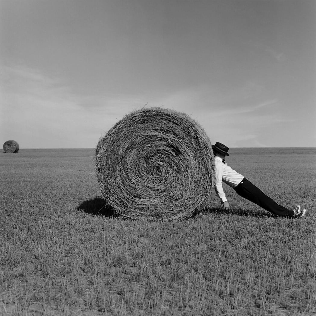 Rodney Smith, Man Leaning Against Hay Bale, Alberta, Canada