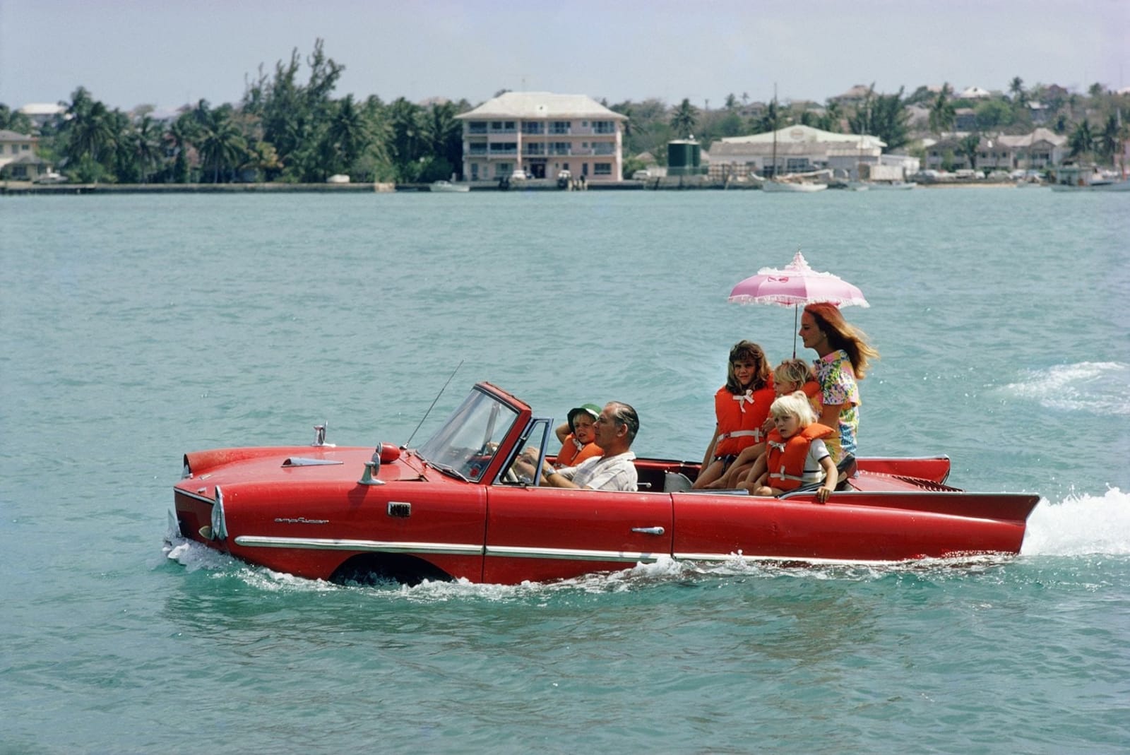 Slim Aarons, Sea Drive: Film producer Kevin McClory takes his wife Bobo Segrist and their family for a drive in...