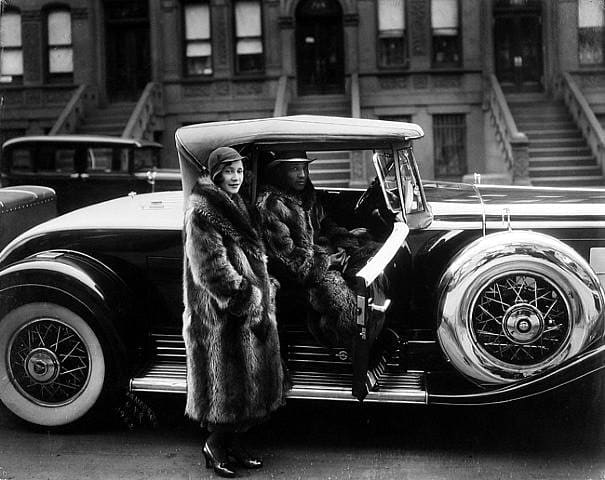 James Van Der Zee, Harlem Couple wearing racoon coats with a Cadillac, taken on West 127th Street, 1932