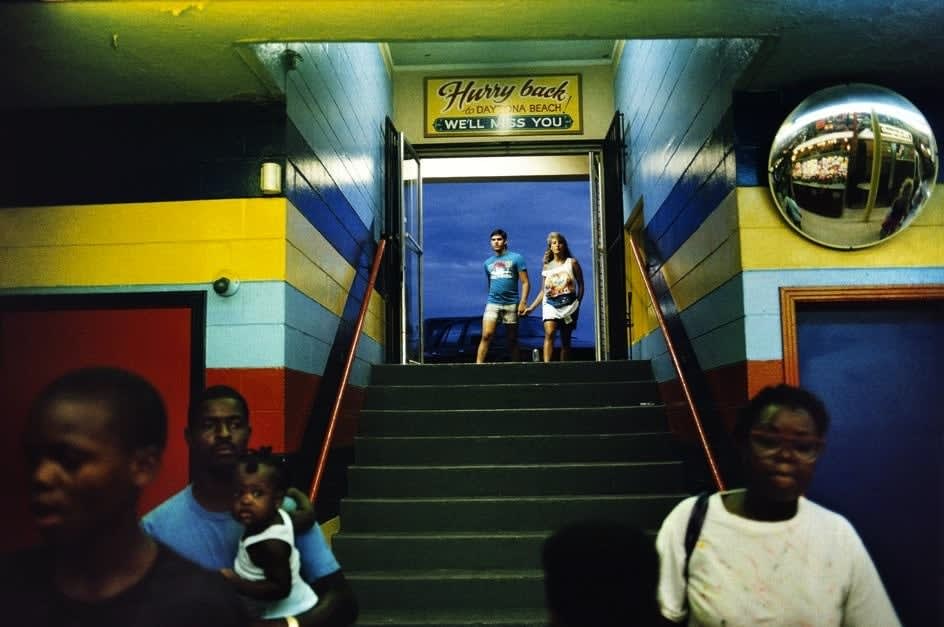 Alex Webb, Daytona Beach (couple at top of staircase/black family), 1988