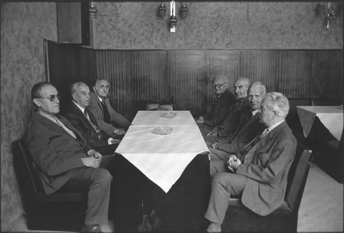 Paul Ickovic, Pilzen, Czechoslovakia (Seven Men Seated at Table), 1990