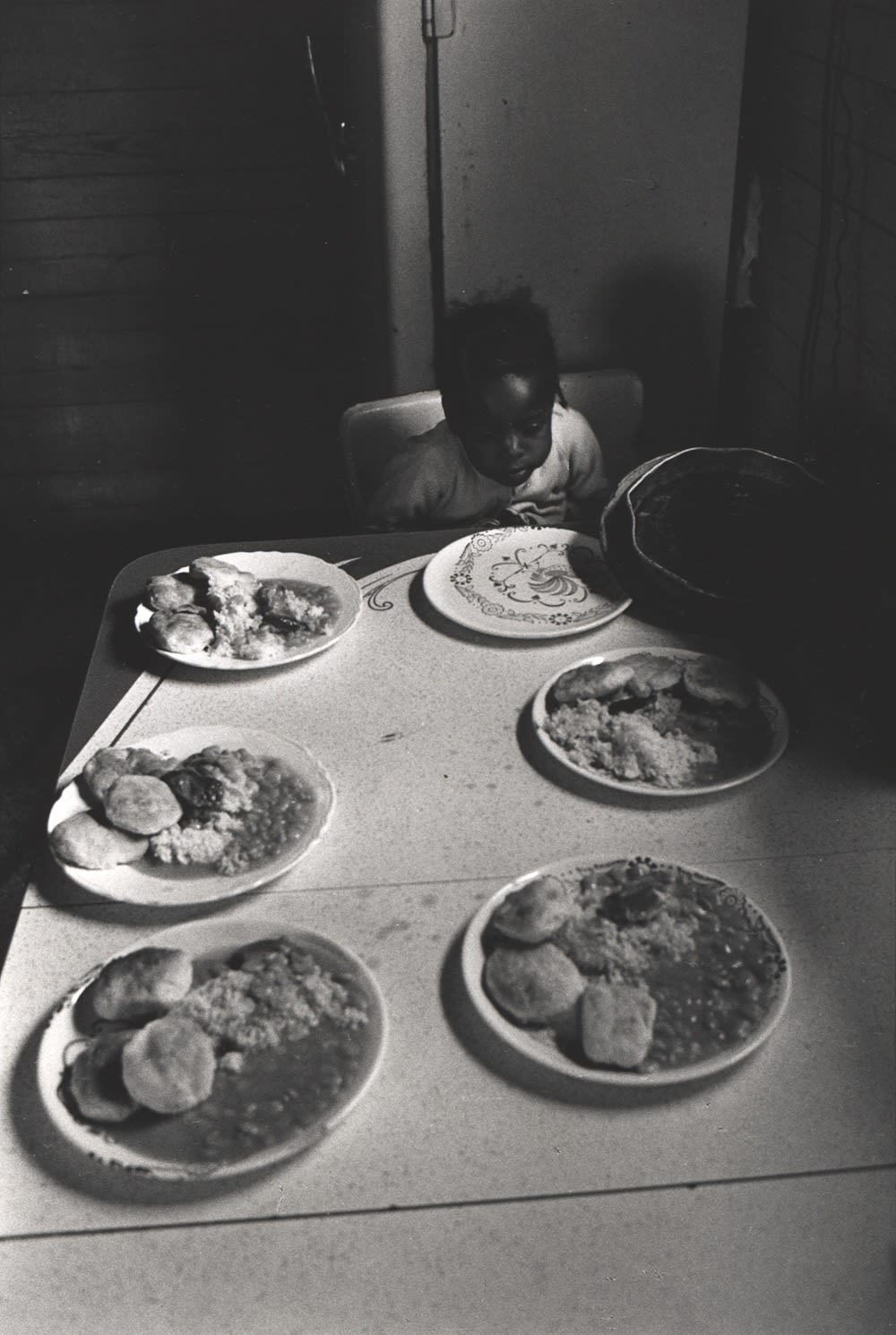 Constantine Manos, Untitled, Sharecroppers, South Carolina (lone child at dinner table), 1965