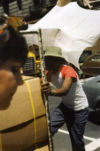 Helen Levitt, Untitled, New York (man pushing boxes garment district), 1980