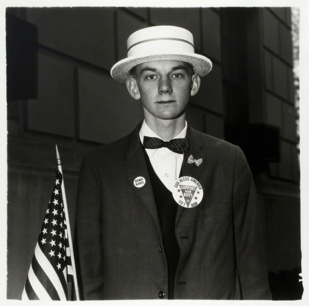 Diane Arbus, Boy with a straw hat waiting to march in a pro-war parade, New York City, 1967