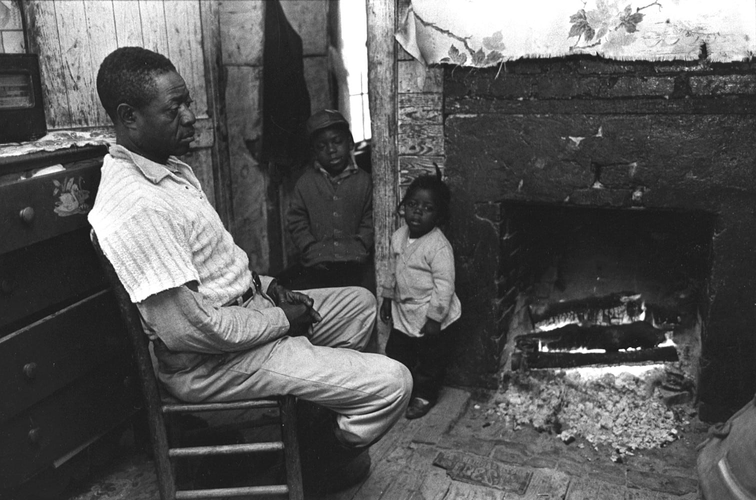 Constantine Manos, Untitled, Sharecroppers, South Carolina (man and 2 children near fireplace), 1965