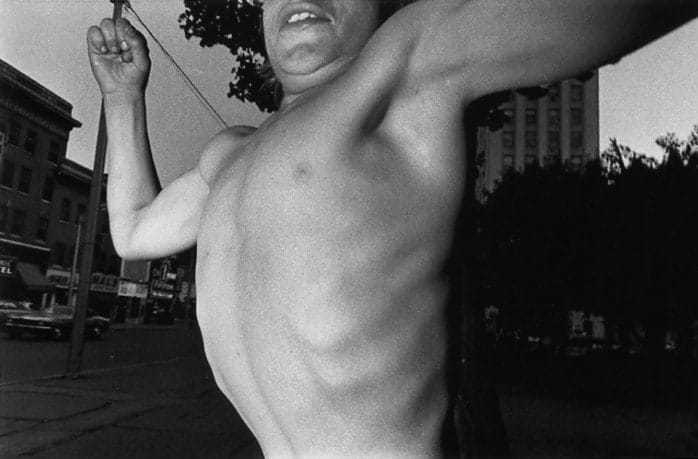 Mark Cohen, Public Square, Wilkes-Barre, Pennsylvania (boy flexing his chest), 1974