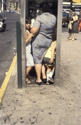 Helen Levitt, Family in phone booth, 1988
