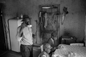 Constantine Manos, Untitled, Sharecroppers, South Carolina (interior, man drink from a ladle 2 children), 1965