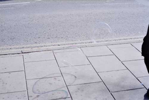 Rinko Kawauchi, Untitled, [bubbles on street]From the series "Murmuration", 2010