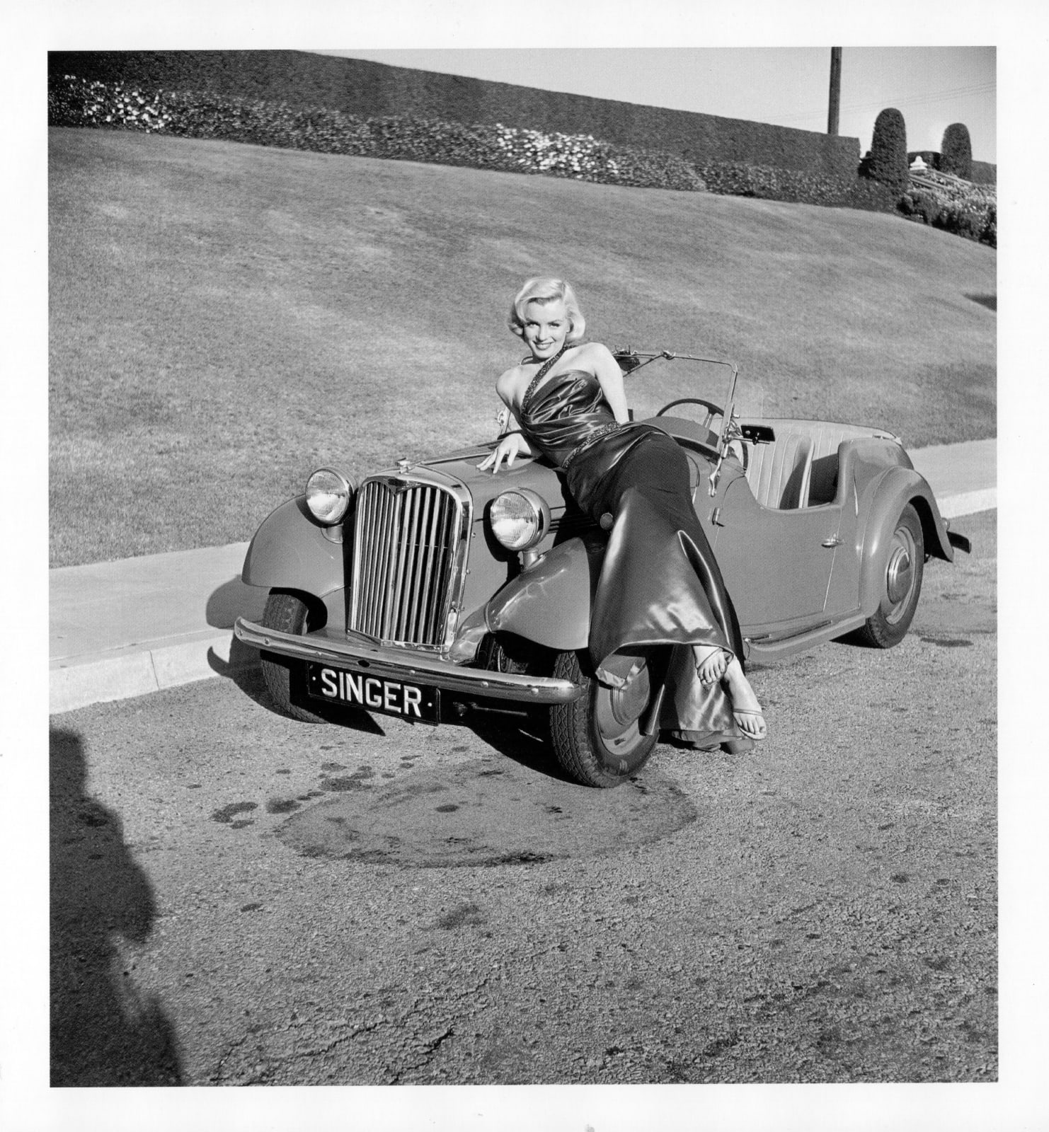 Frank Worth, Marilyn Monroe Leaning Against Singer Automobile, 1953
