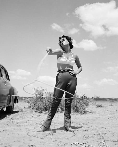 Frank Worth, Elisabeth Taylor with lasso on set of 'Giant', 1955