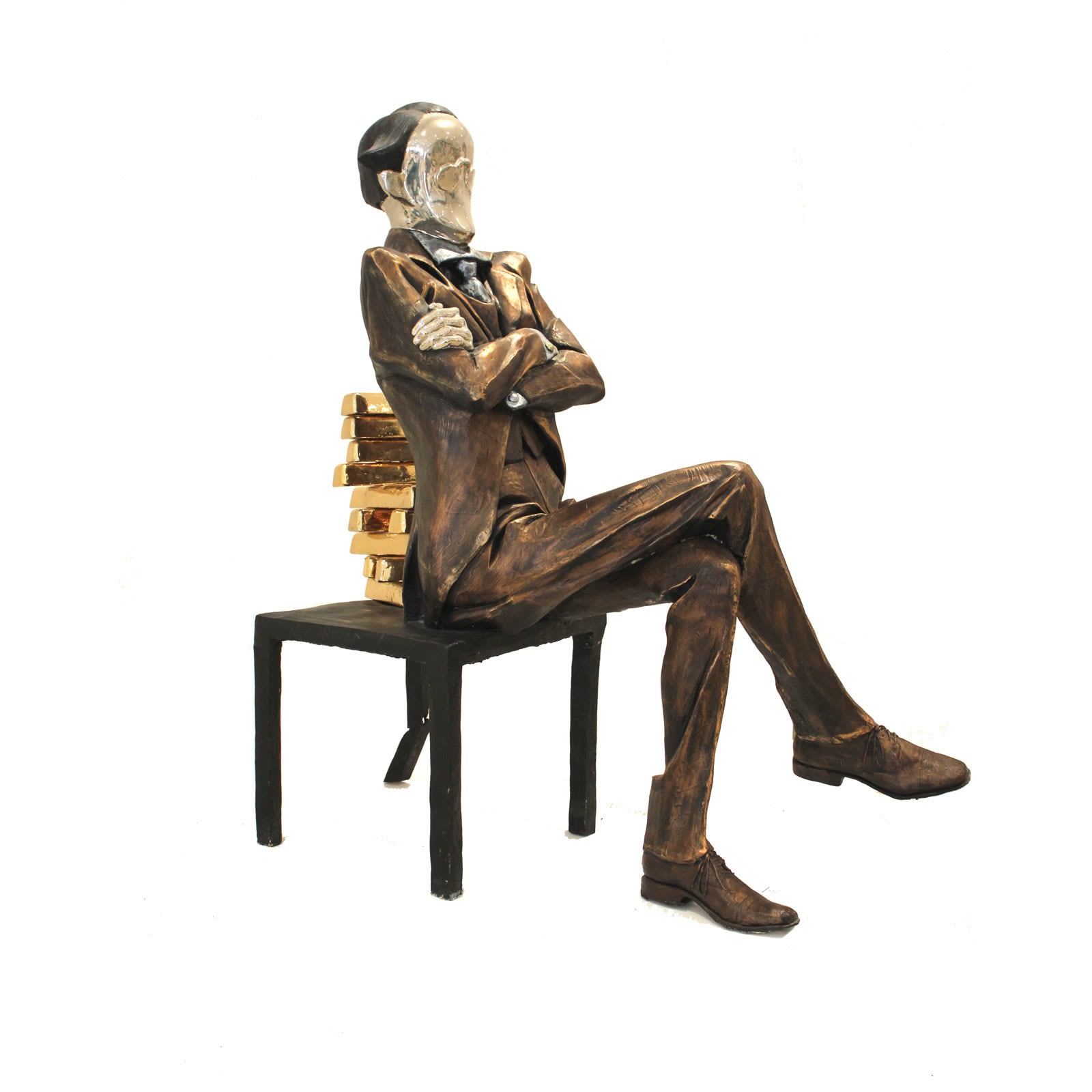 A large sculpture of a banker seated on a chair with a backrest made of stacked gold bullion. The figure, dressed in a formal suit with arms crossed, has a polished, reflective face that adds a surreal element to the piece. One chair leg is visibly bending under the weight of the gold, symbolizing the burden of wealth.