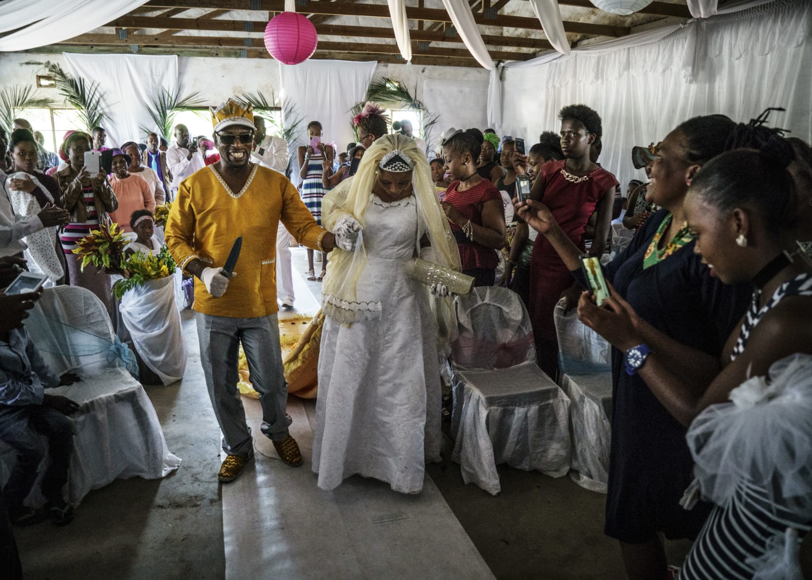 Jonas Bendiksen, Moses and Angel walking up the aisle, South Africa, 2016