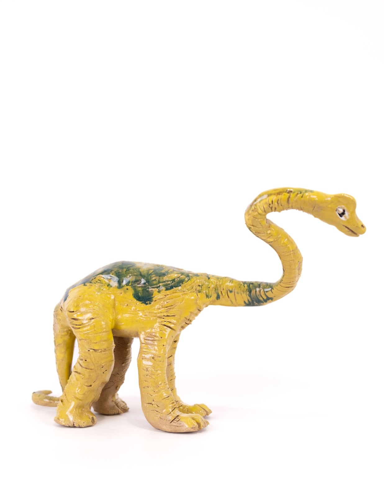 Ceramic sculpture of a yellow Brachiosaurus with blue markings