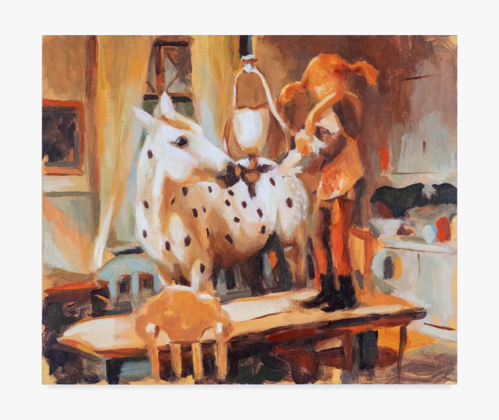 A painting by Jen Keltos of a dreamy, warm, interior scene. A young red-headed girl with pigtails stands up on the table in a small dining room. Next to her stands a milky white horse with black polkadots like a dalmation. A hanging glass lamp glows between them.