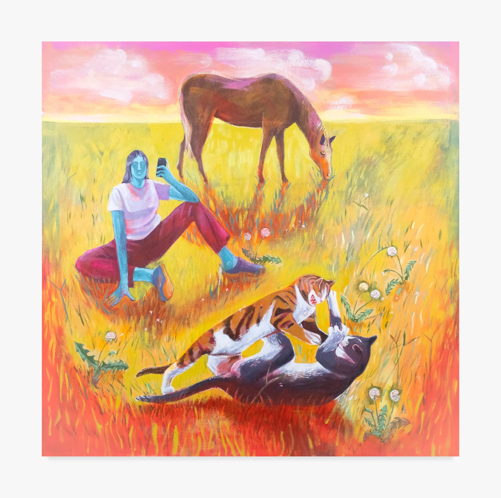 A painting by Maddie Stratton. In the foreground, two cats, one orange and one tabby, tussle in the green and red grass. Behind them, a blue woman in pink pants and a pink shirt sits in the grass recording them on her phone. Behind her, a brown horse eats grass against a pink cloudy sky.