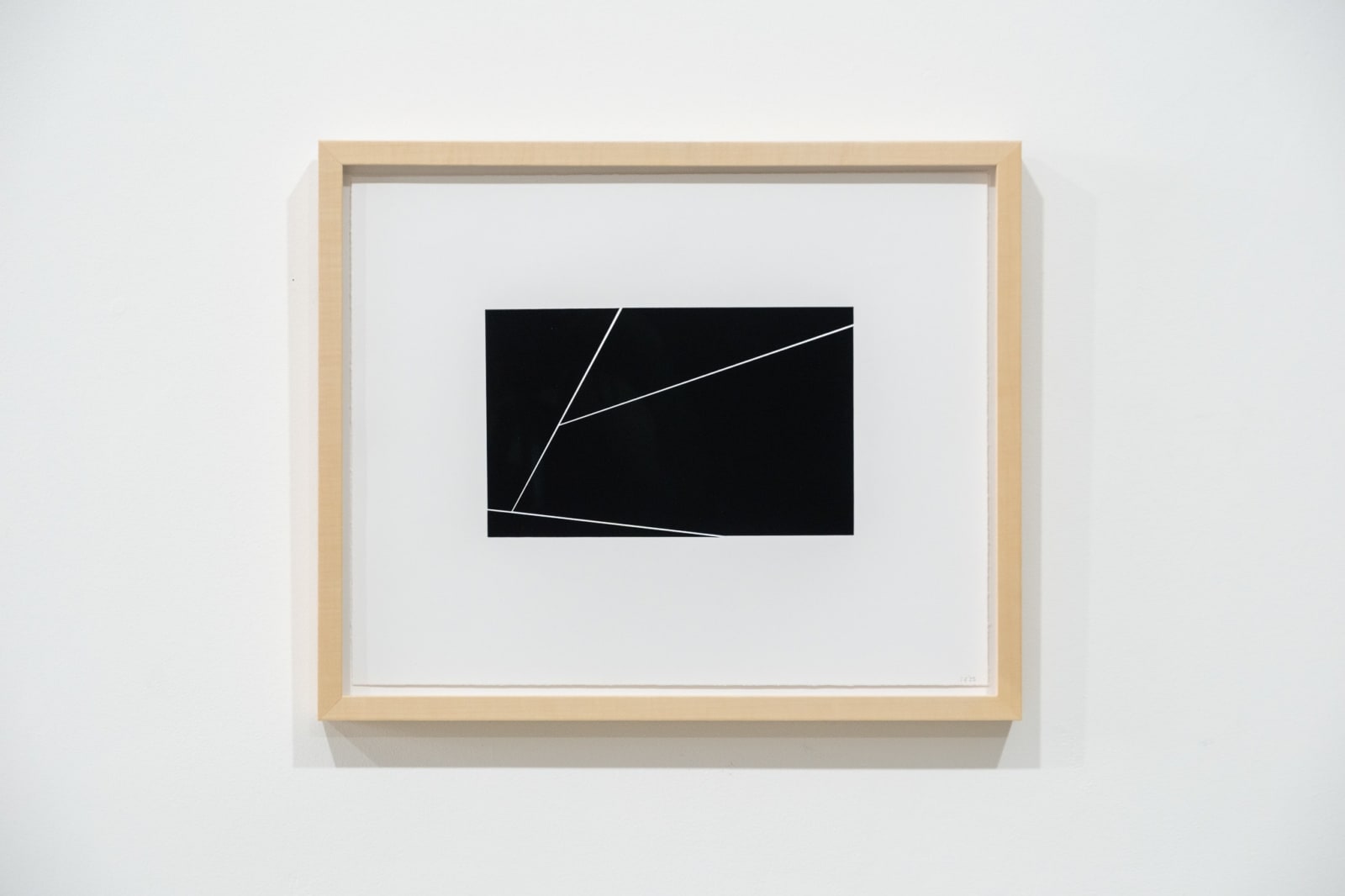 A framed black and white abstract screen print by Ian Gouldstone. A black rectangle is divided into multiple sections by thin white lines.