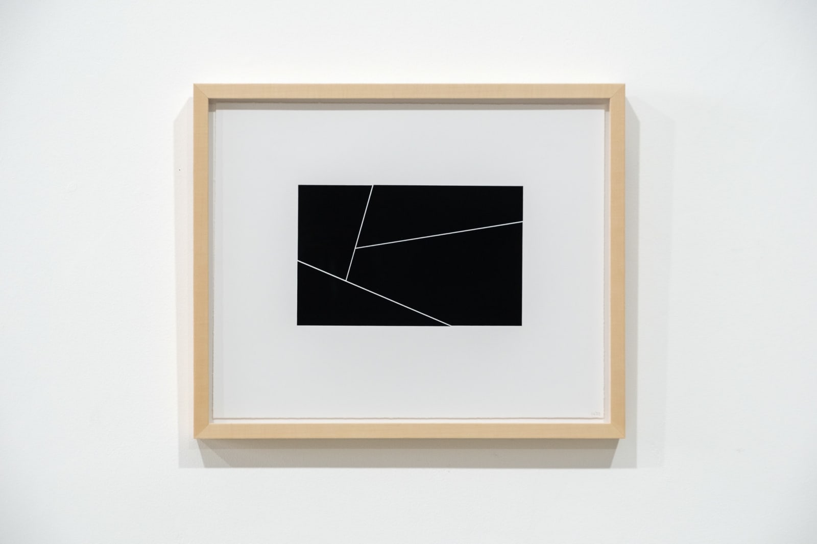 A framed black and white abstract screen print by Ian Gouldstone. A black rectangle is divided into multiple sections by thin white lines.