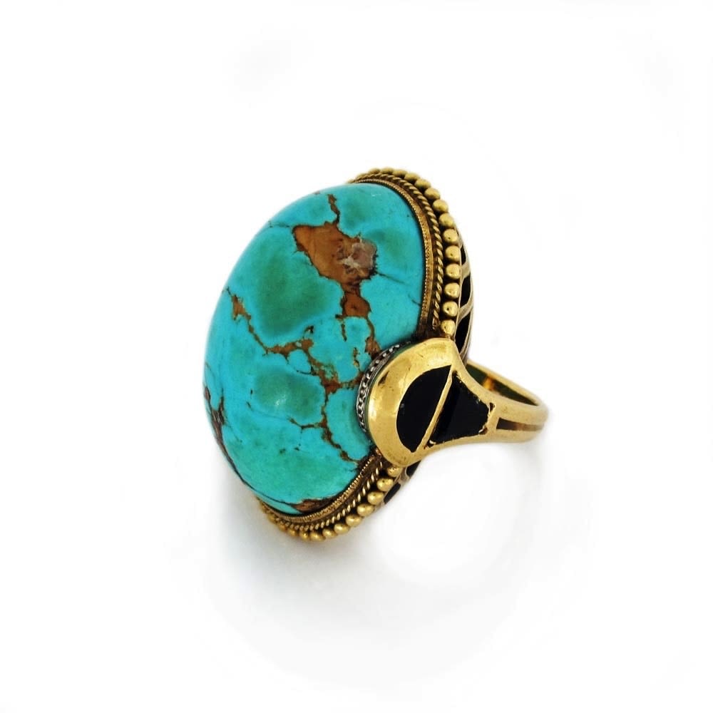 An Egyptian Revival Turquoise, Onyx, and Gold Ring, c. 1910