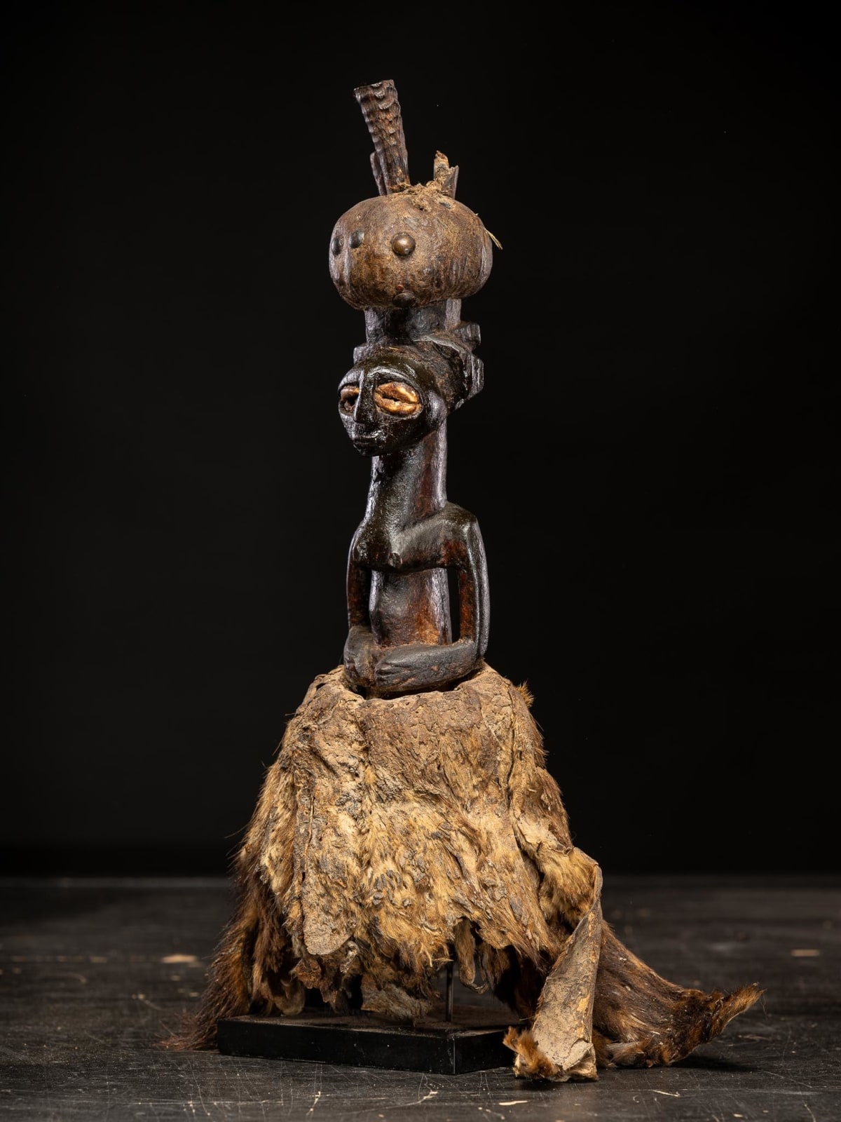 Kusu Power figure with cauris inlaid eyes topped with small antilope horns. Kusu People, DRC., 1st half 20th Century or earlier