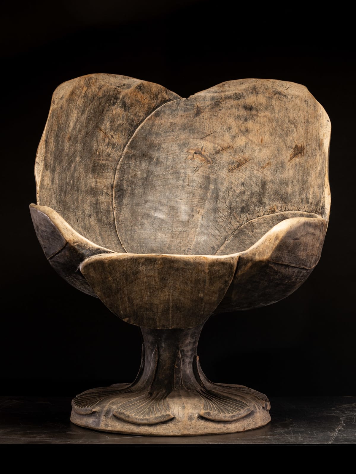 Set of 4 hardwood chairs hand-carved out of one solid block in the form of a stylized flower-form.,
