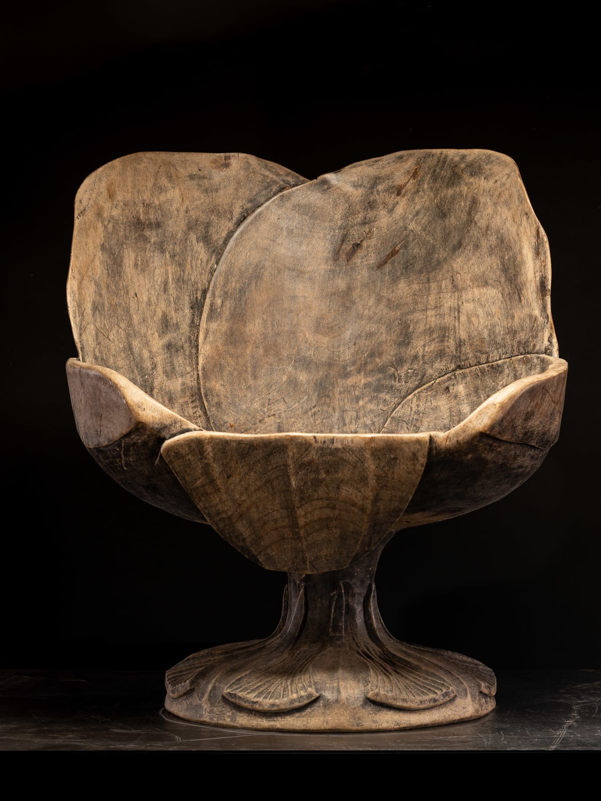 Set of 4 hardwood chairs hand-carved out of one solid block in the form of a stylized flower-form.,