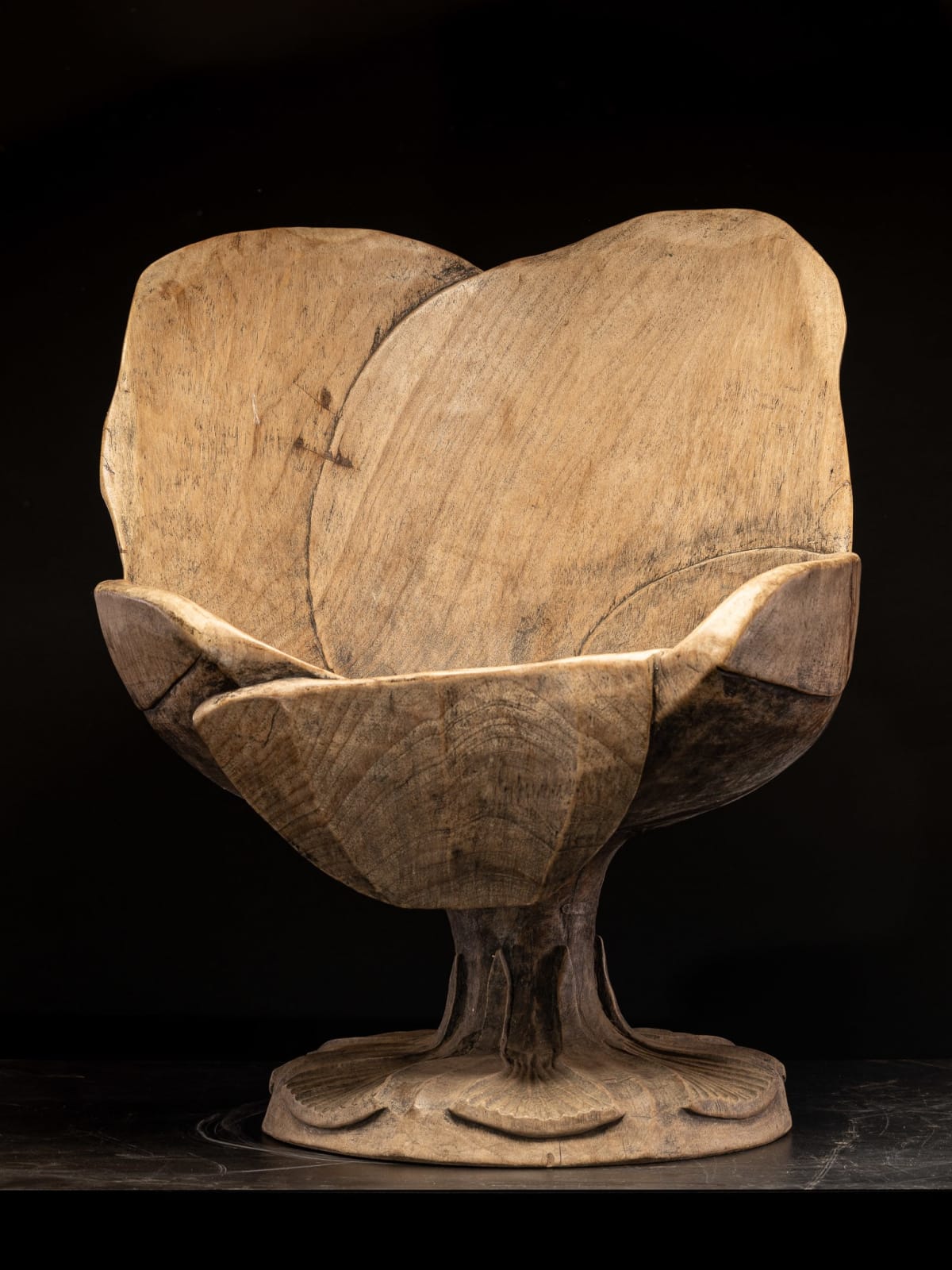 Set of 4 hardwood chairs hand-carved out of one solid block in the form of a stylized flower-form.,