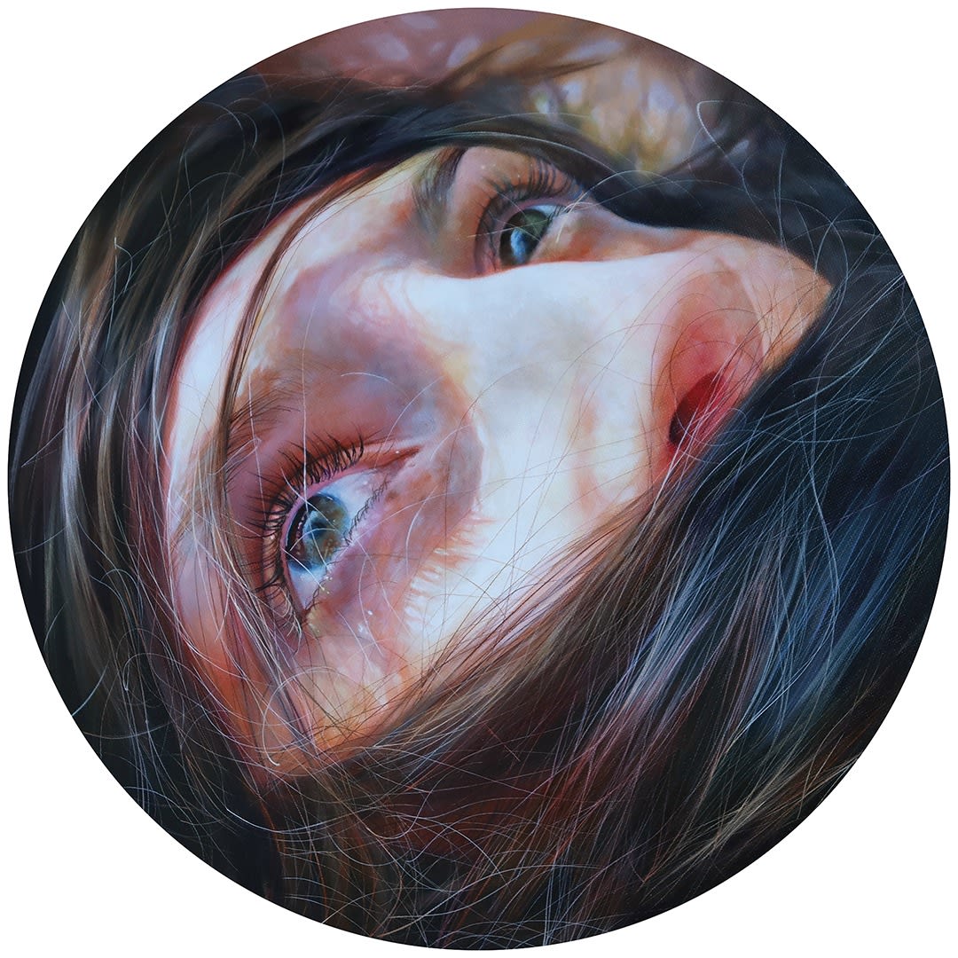woman's face shrouded behind hair