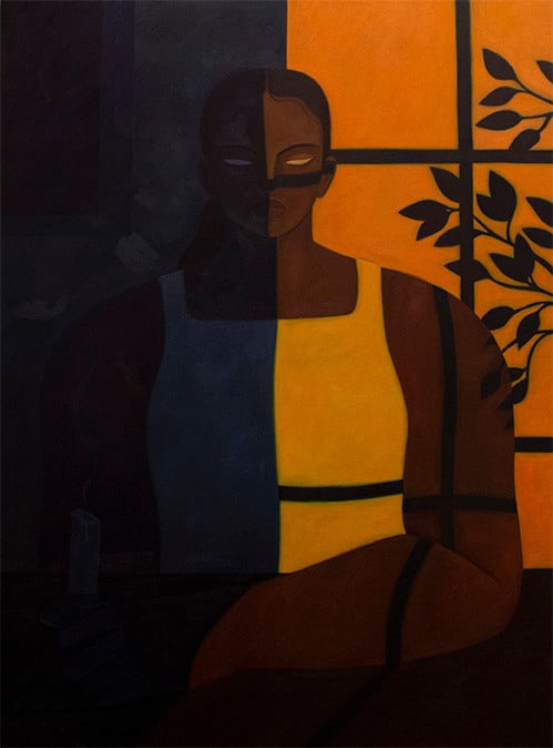 Woman sitting with a window shadow cast over her face, half in orange light and half in dark