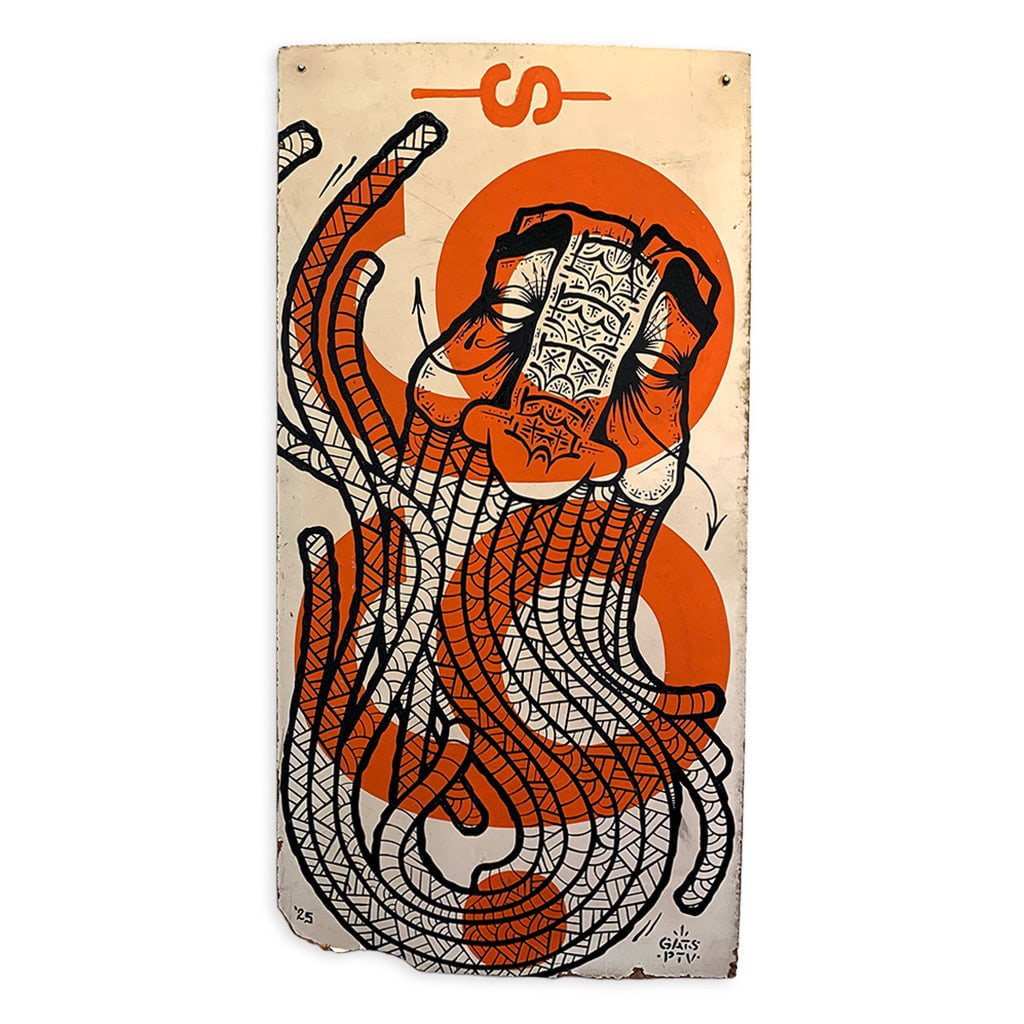 A hand-painted sign of GATS's signature masculine face with a long beard and intricate symbols/patterns.