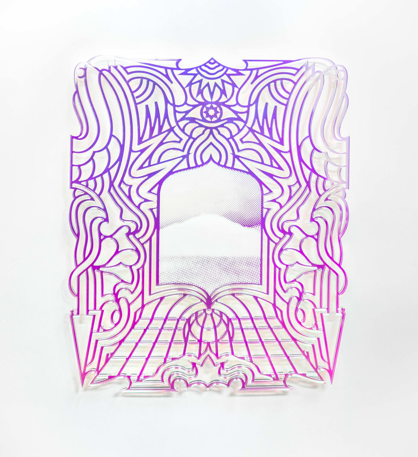 laser-cut transparent acrylic plaque with iridescent film with a design featuring a an eye, arrows, a sun and flowers.