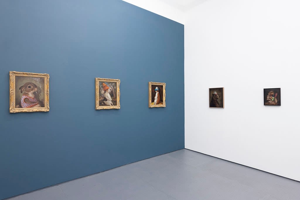 Install photo of Alison Friend's paintings hanging on a blue and white wall