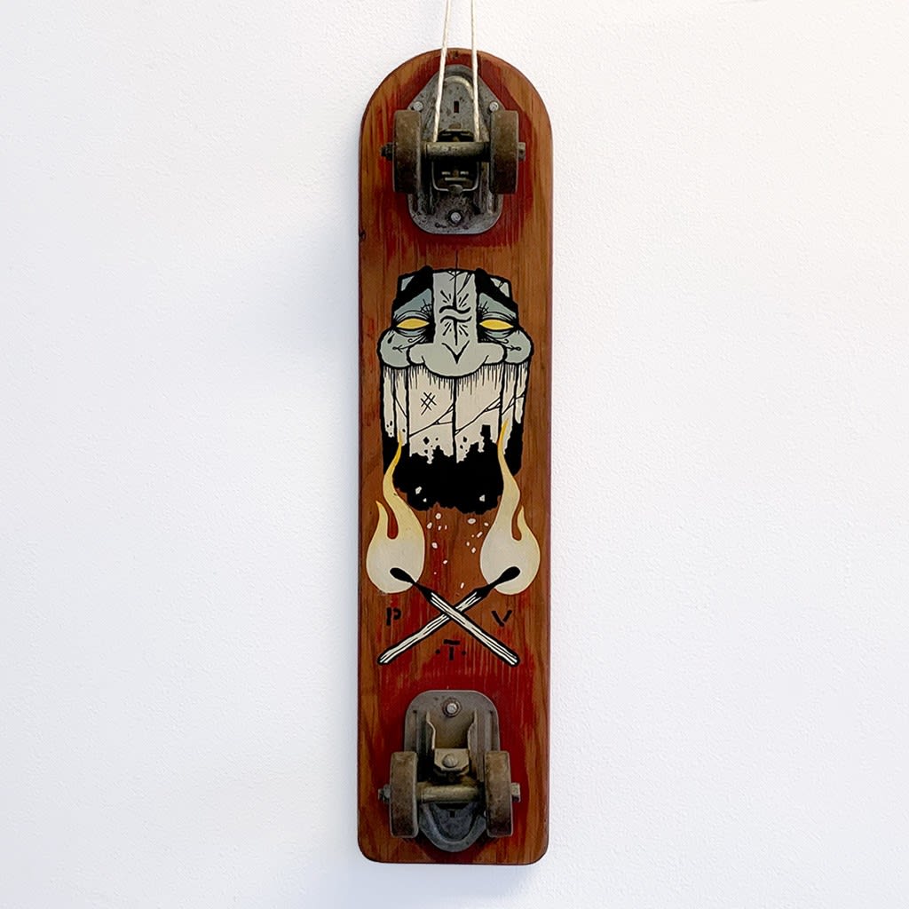 A vintage wood skateboard with a painted image of a masculine face and to lit matches forming an 