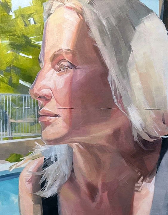 Portrait of a blonde woman looking out with a pool and trees in the background