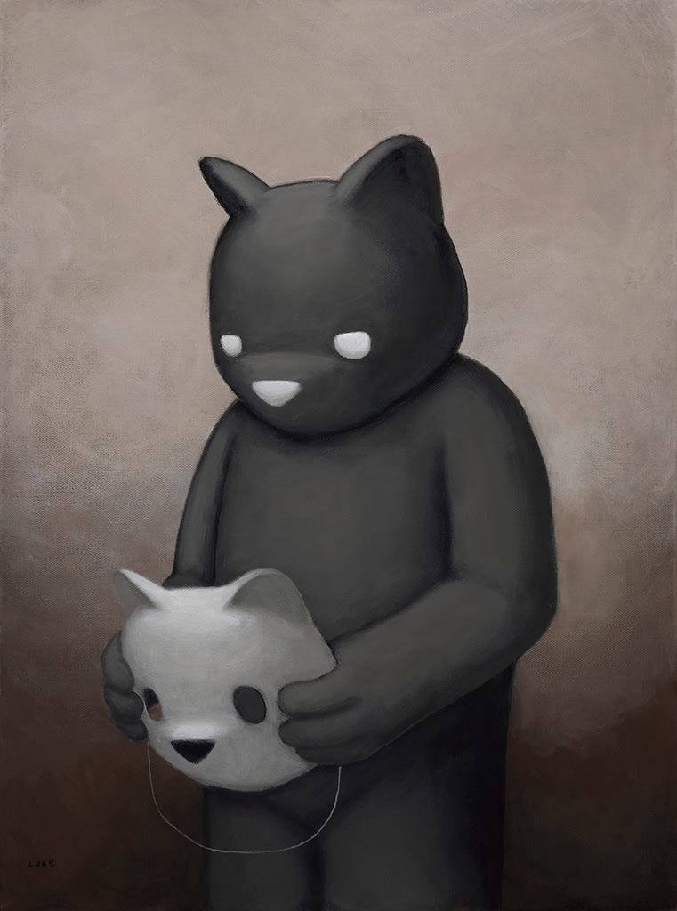 a black bear holding a mask of a white bear face
