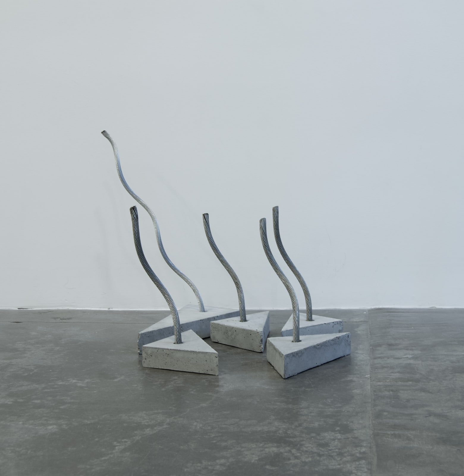 Various shaped cement slabs with wire sticking out