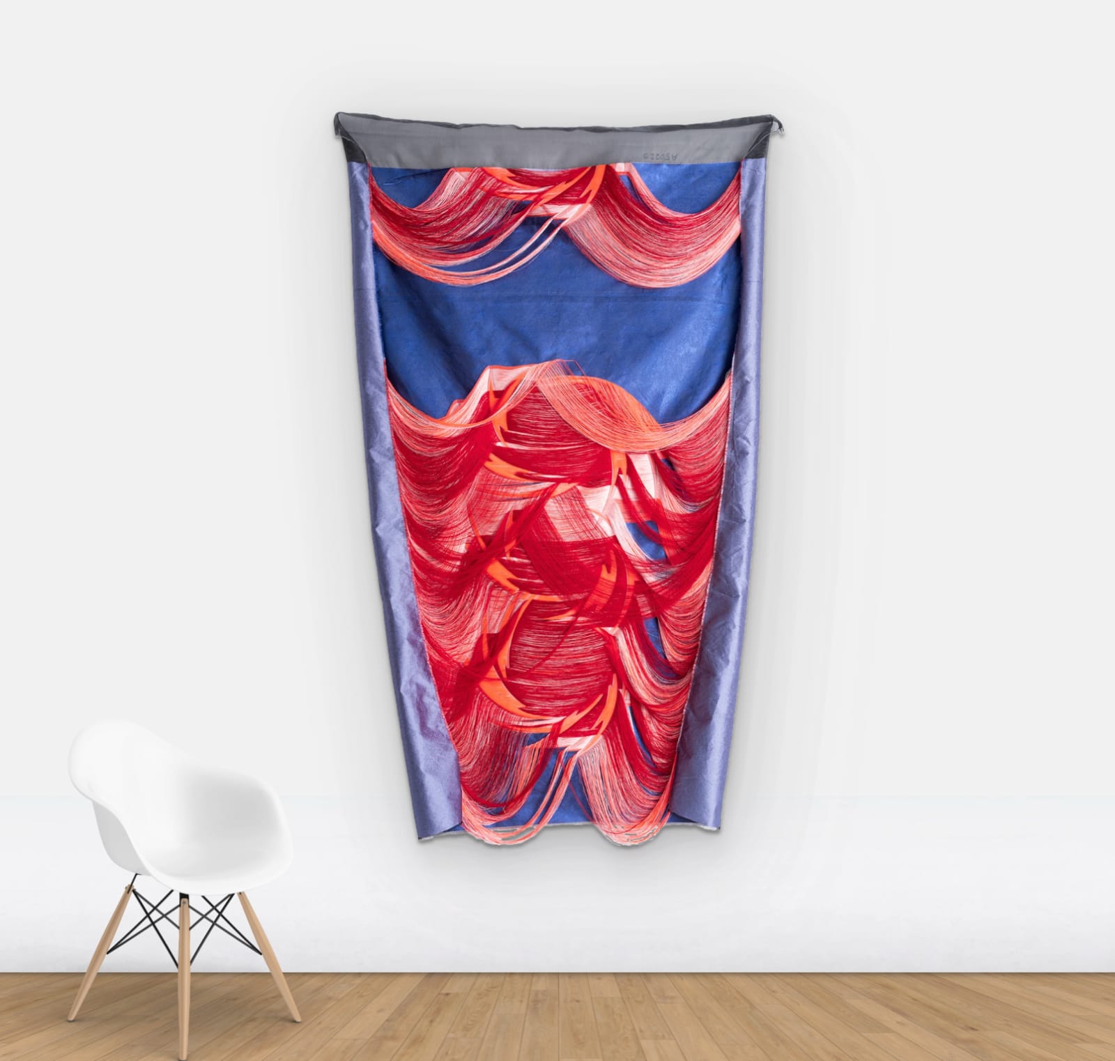 Wall view of Blue and red fabric sculpture hung on wall