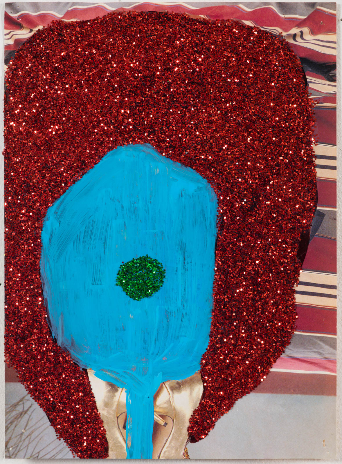 Pornographic magazine covered with a large circular glitter shape and a dot in its center with feet exposed